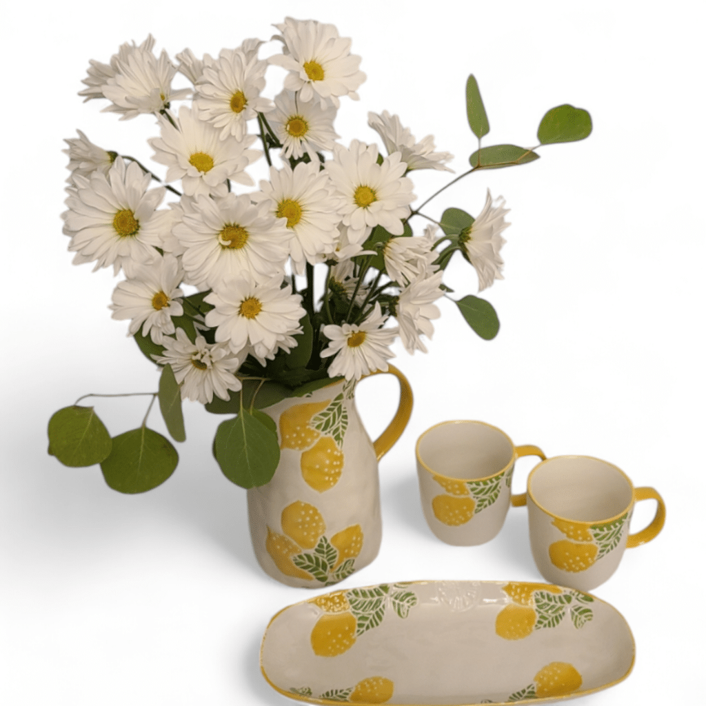 Tracy's Terrace Complete Gift Basket - Florist Atropa Belladonna The complete Gift Basket, includes white daisy bouquet in lemon pitches with 2 matching lemon mugs, and lemon serving tray.