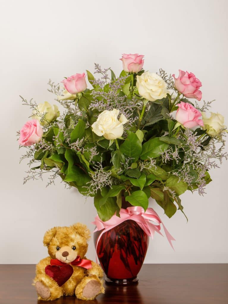 Atropa's Dozen Roses - Florist Atropa Belladonna dozen pink and white roses with soft purple feature our signature atropa belladonna colours, in a vase with a plush bear
