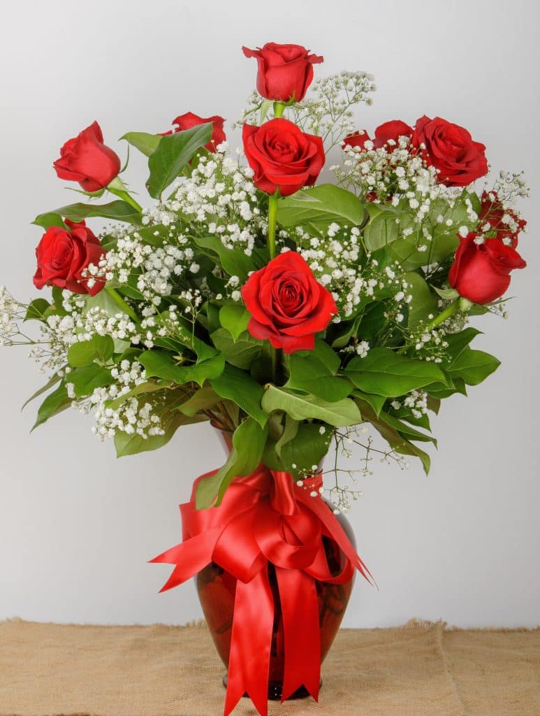 Lancelot's Dozen Red Roses - Florist Atropa Belladonna A Dozen Red Roses, arranged in a beautiful vase with babys breath and greens